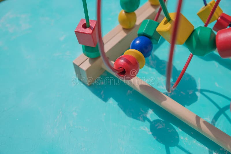 Color toy developmental motor skills of child`s hands on blue background. toys for games in kindergarten, development of royalty free stock photos
