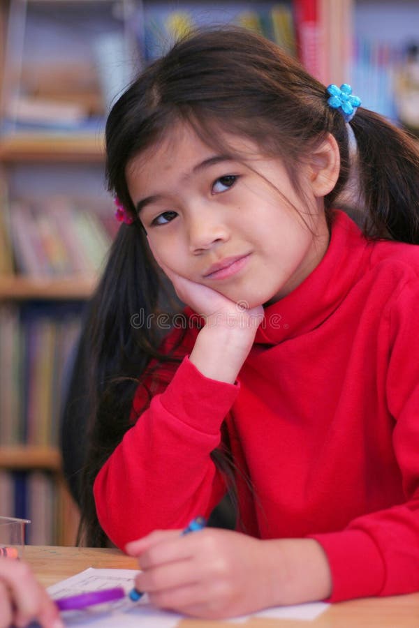 Menina de seis anos a colorir foto de stock