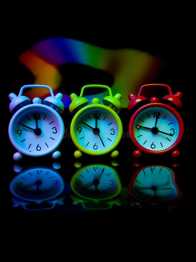 Colored alarm clock with colorful reflection stock photo