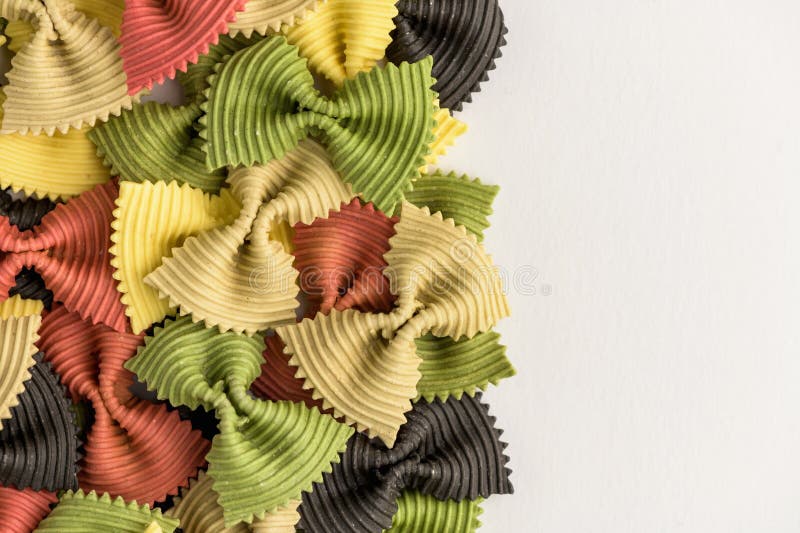 Colored Bow Tie Pasta. Closeup Multiple Farfalle Isolated on White