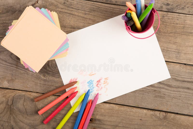 Colored Crayons and Blank Page on the Wooden Table Stock Photo Image