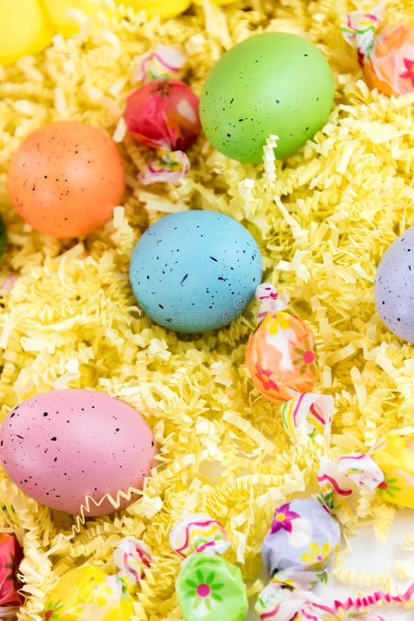 Colored Easter Eggs, Chicks, Candy and Bucket on Grass Stock Image