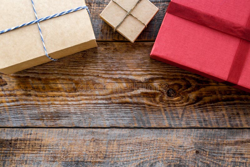 Colored gift boxes on wooden background top view copyspace