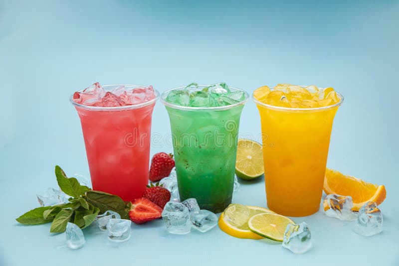 Colored Lemonades In Plastic Cups With Ice, Fruits And Berries Stock ...