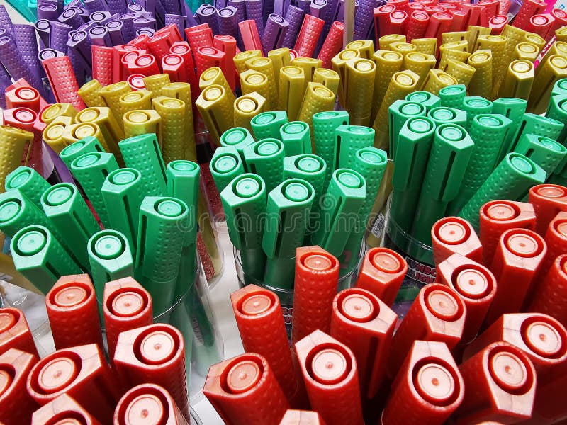 Colored markers for writing placed in jars stock image