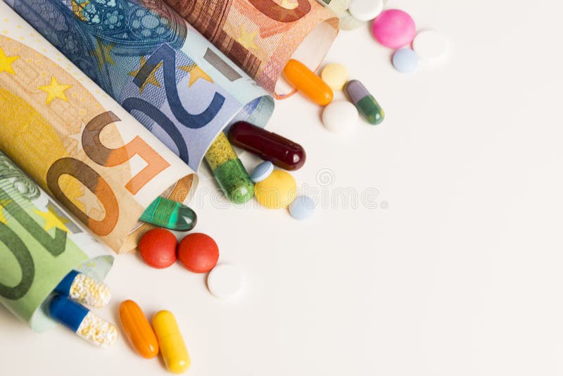 Colored medical pills from rolled up euro banknotes, money from pharmaceutical industry concept