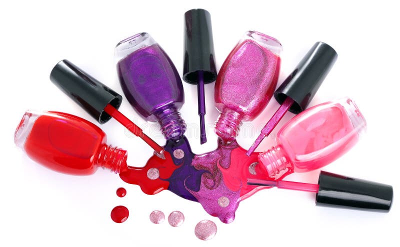 Ð¡olored nail polish splash, spilling from bottles royalty free stock images