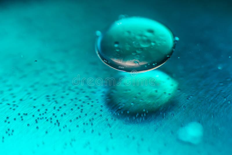 Colored Oil Drops and Bubbles on a Metal Gear Engine Surface. Closeup