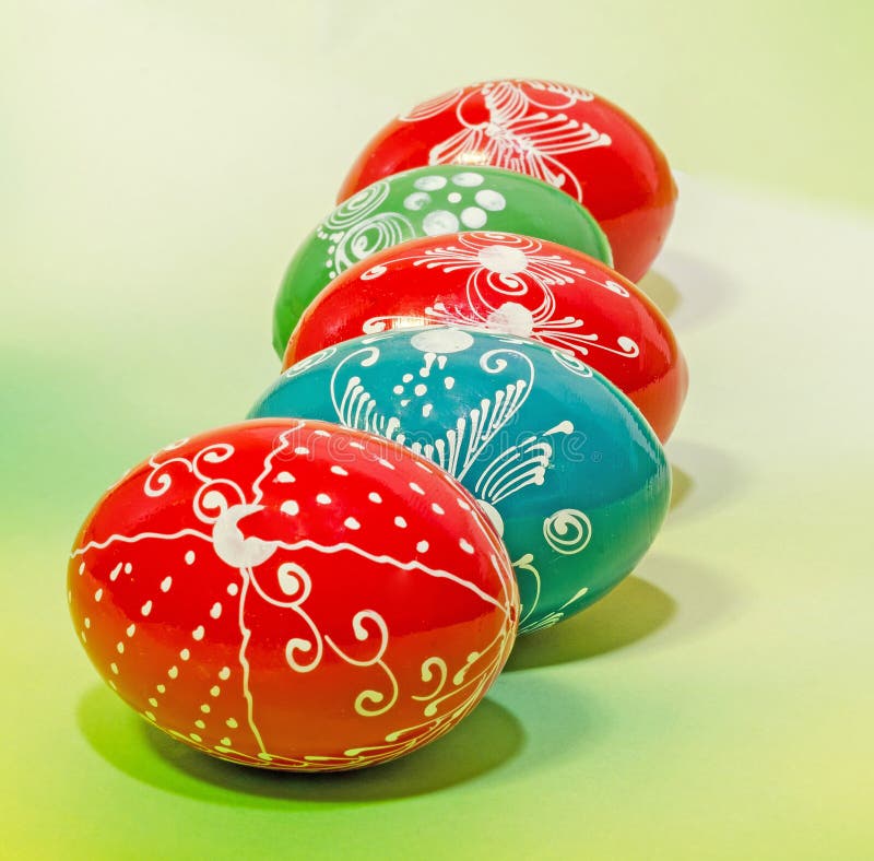 Colored painted romanian traditional Easter eggs, close up, gradient background