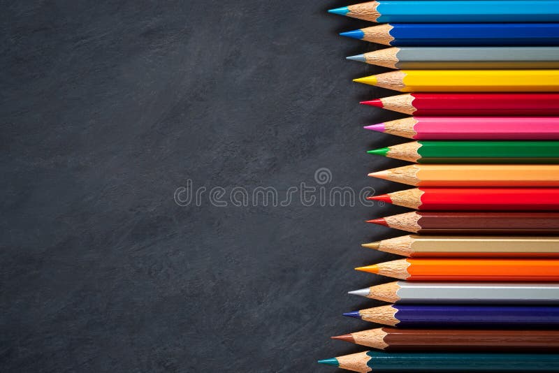 Colored Pencils On Chalkboard Background. Stock Image Image of