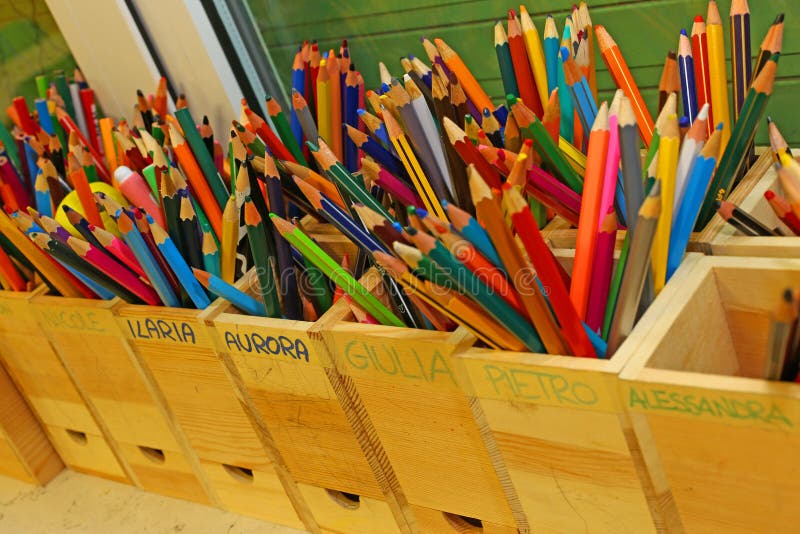 Colored pencils with the names of the children of the school class stock image