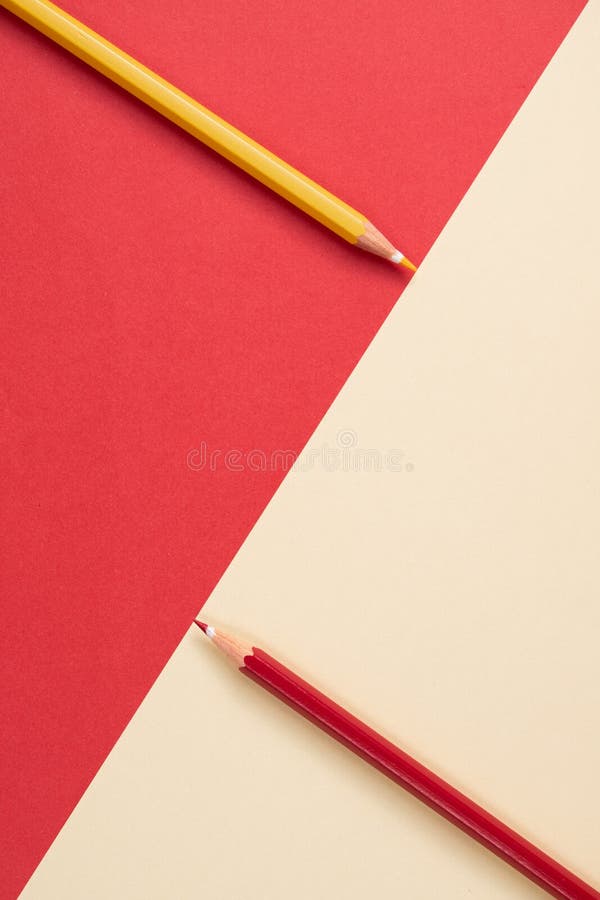 Colored pencils touching the division of the image which is a diagonal line dividing the area stock images