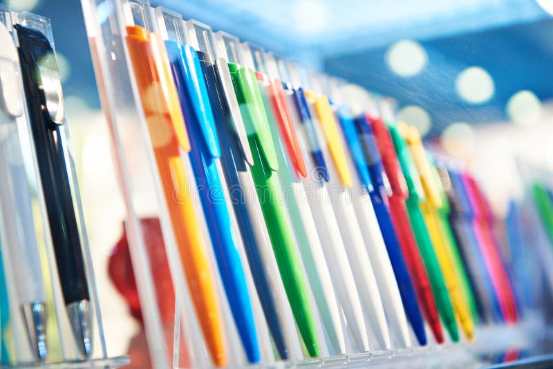 Colored plastic pens on store display stock images