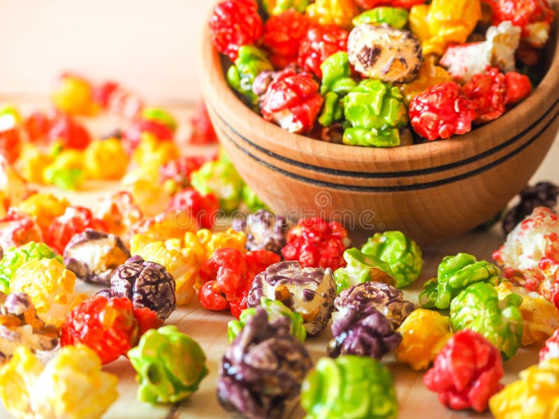 Sprinkled popcorn on a wooden table.