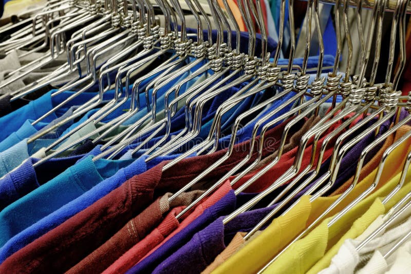 Colored Shirts on Hangers Set on Rack To Sell in Store Stock Photo