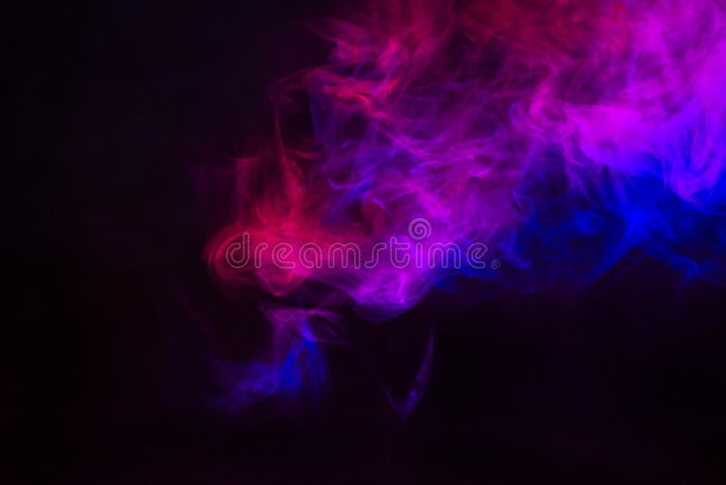 Colored smoke on a black background. Blurred abstract background. Theatrical effects. Highlighting the stage in the theater.