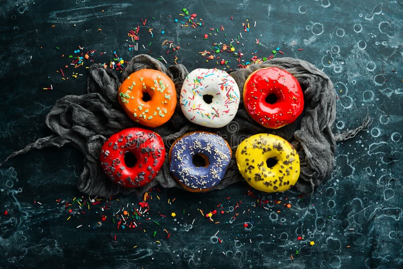 Colored Sweet Baked Donuts on a Black Background. Stock Photo Image