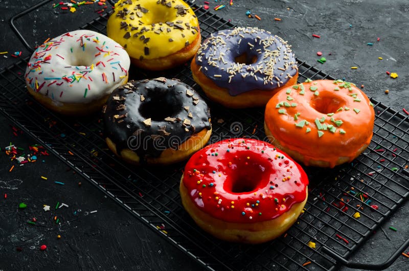 Colored Sweet Baked Donuts on a Black Background. Stock Photo Image