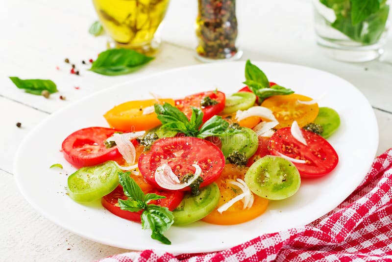 Colored tomato salad with onion and basil pesto. royalty free stock images Colored tomato salad with onion and basil pesto. royalty free stock images
