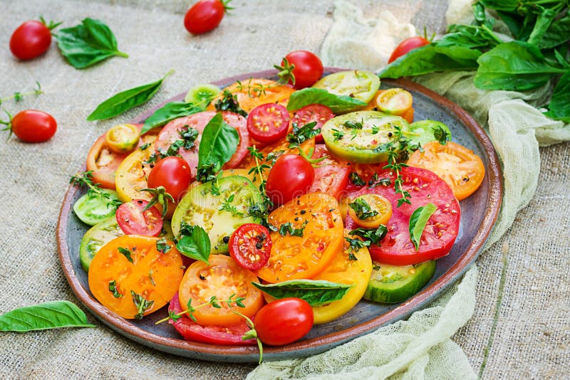 Colored tomato salad with onion and basil. Vegan food. stock photography Colored tomato salad with onion and basil. Vegan food. stock photography