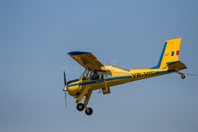 Colored Ultra Light Plane Flying at Air Show - Isolated Editorial Photo