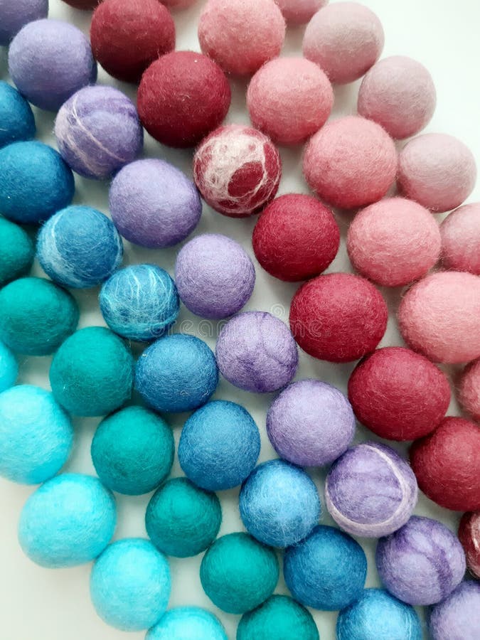 Colored wool. Beads made of wool. Balls of wool. Felt of defferent colors