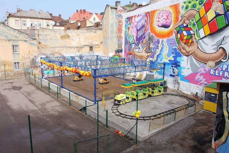 Colorful abandoned amusement park with toy cars and trains for children