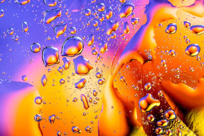 Colorful abstract background. Water drops rainbow colors on glass. Amazing abstract water drops on glass texture or background.