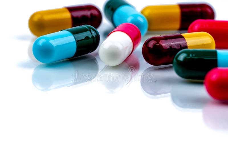 Colorful antibiotic capsule pills on white background. Pharmaceutics concept. Antibiotic drug resistance. Pharmaceutical industry. stock photography Colorful antibiotic capsule pills on white background. Pharmaceutics concept. Antibiotic drug resistance. Pharmaceutical industry. stock photography