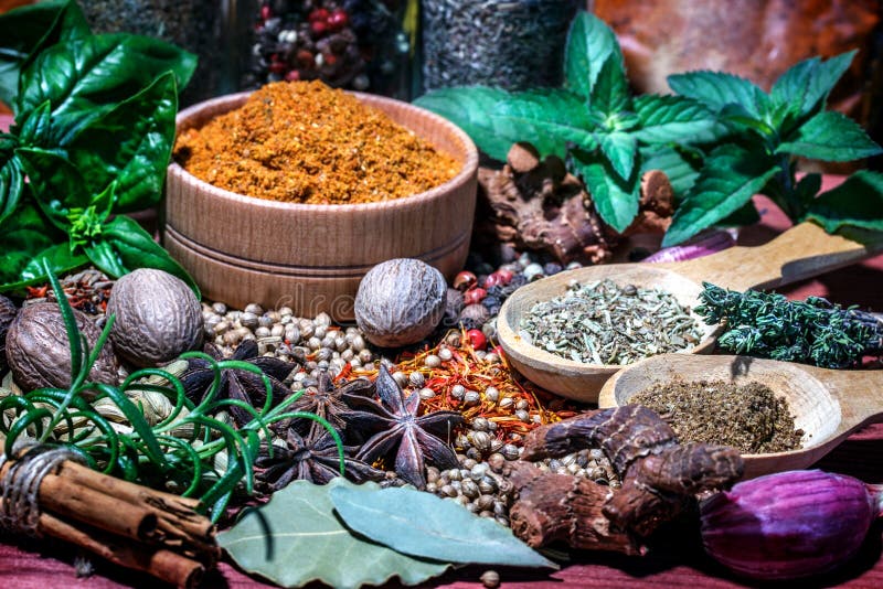 Colorful Aromatic Spices and Herbs on a Wooden Brown Backgrownd Stock