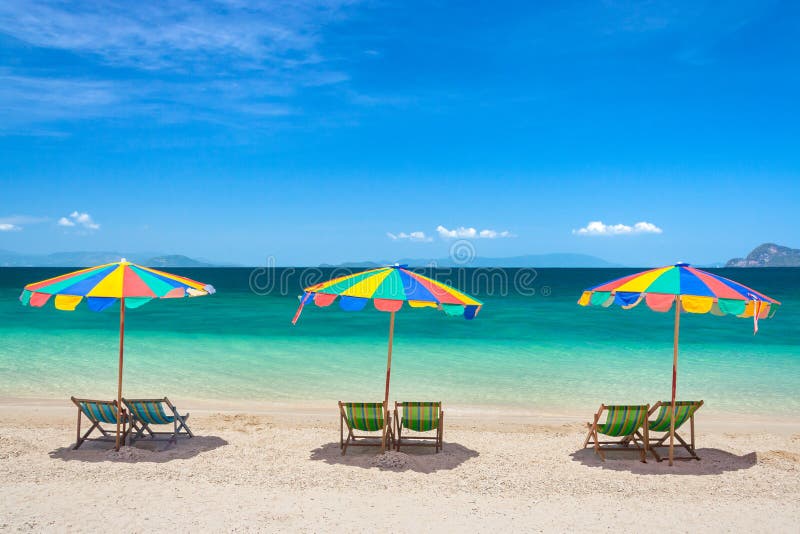 Colorful beach chairs with umbrellas on a sunny day