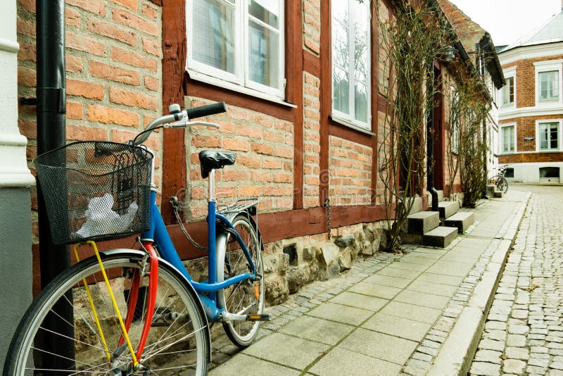 Colorful bike standing against a wall of an old half timbered house in Lund, Sweden - Mars 25, 2017