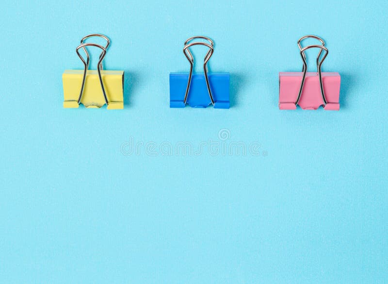 Colorful Binder Clips on Blue Paper Background Stock Image Image of