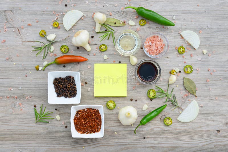 Colorful blank stickers for notes and pepper, bay leaf, rosemary, onions, Himalayan salt, olive oil, soy sauce on. Board, recipes.