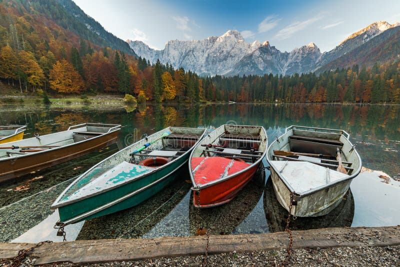 Colorful boats at scenic Fusine Lake in Italian Alps