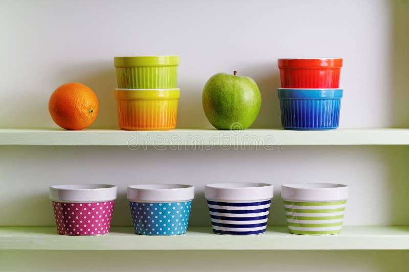 Colorful bowls on a kitchen shelf