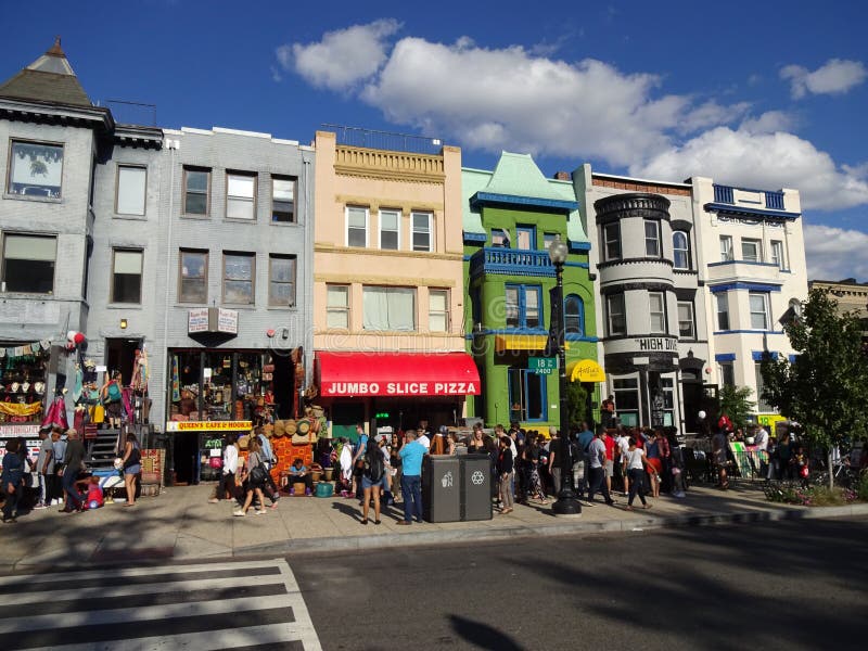 Photo of people and colorful buildings in adams morgan in washington dc on 9/13/15 on adams morgan day. This diverse neighborhood has many restaurants and retail stores. Adams morgan day is big party or festival featuring music, food and arts and crafts. Photo of people and colorful buildings in adams morgan in washington dc on 9/13/15 on adams morgan day. This diverse neighborhood has many restaurants and retail stores. Adams morgan day is big party or festival featuring music, food and arts and crafts.