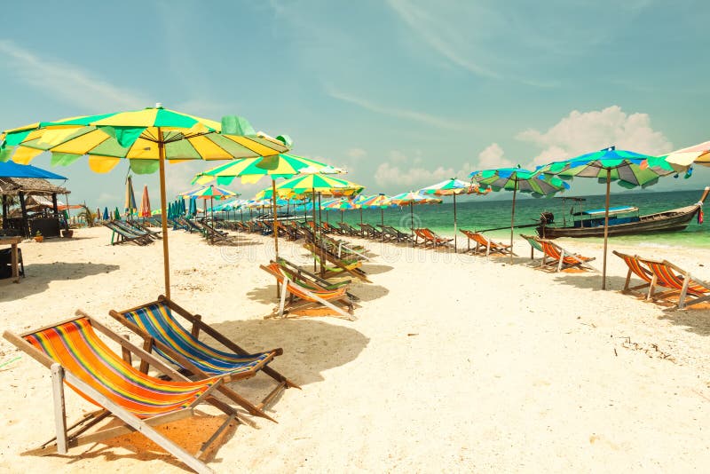 Colorful chairs and umbrella on tropical beach at Koh Khai Nok I