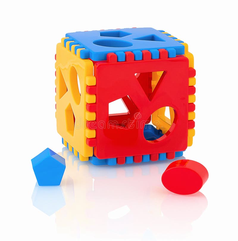 Colorful children`s toy shape sorter isolated on white background with shadow reflection. The cubed shape sorter.