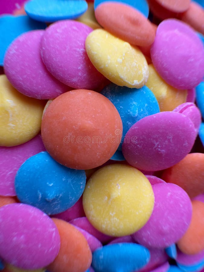 Pink Chocolate Candy Melts on Pink Polka Dots Background Stock Photo