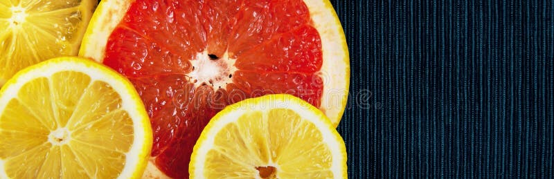 Colorful citrus fruit slices. Lemons and grapefruits. Panorama. Banner. stock photos
