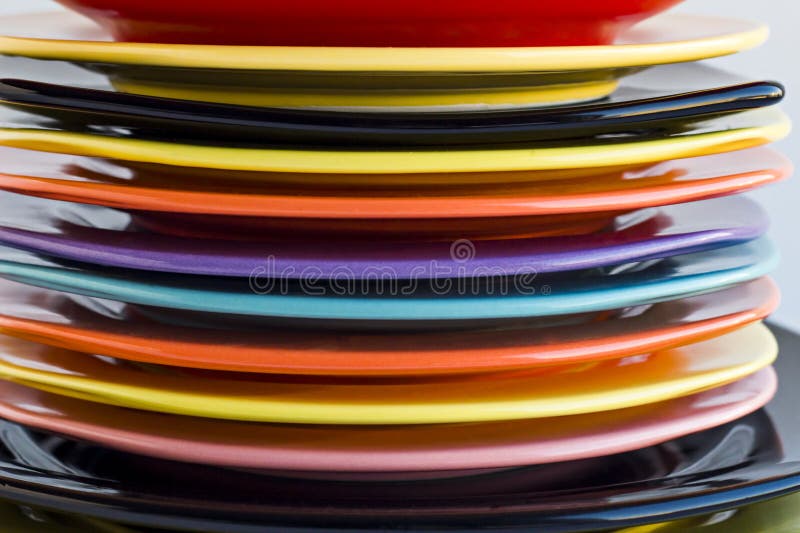 Colorful,clean Dinner Plates Stacked on White Surface. Stock Photo
