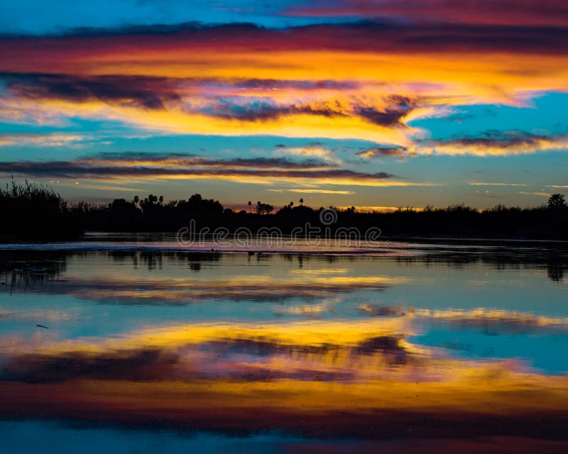 Cotton candy clouds over the mighty Colorado river stock photography