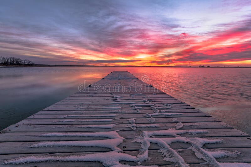 Colorful Colorado Sunrise with beautifl clouds and a fishing doc