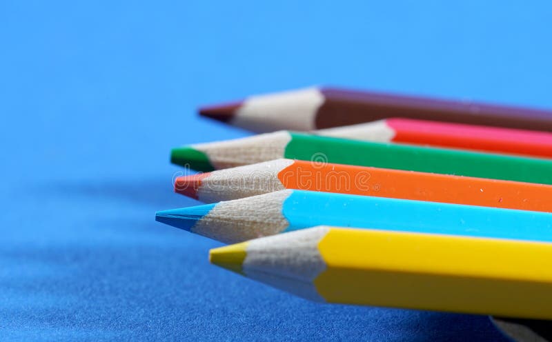 Colorful crayons, pencils with plain paper as a background with structure stock photography