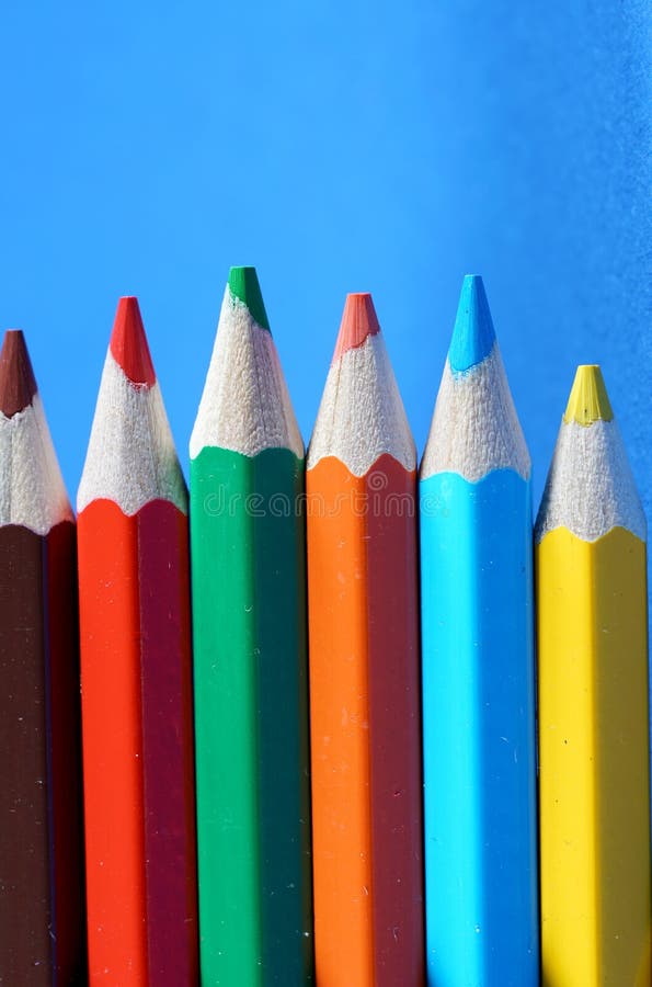 Colorful crayons, pencils with plain paper as a background with structure stock photo