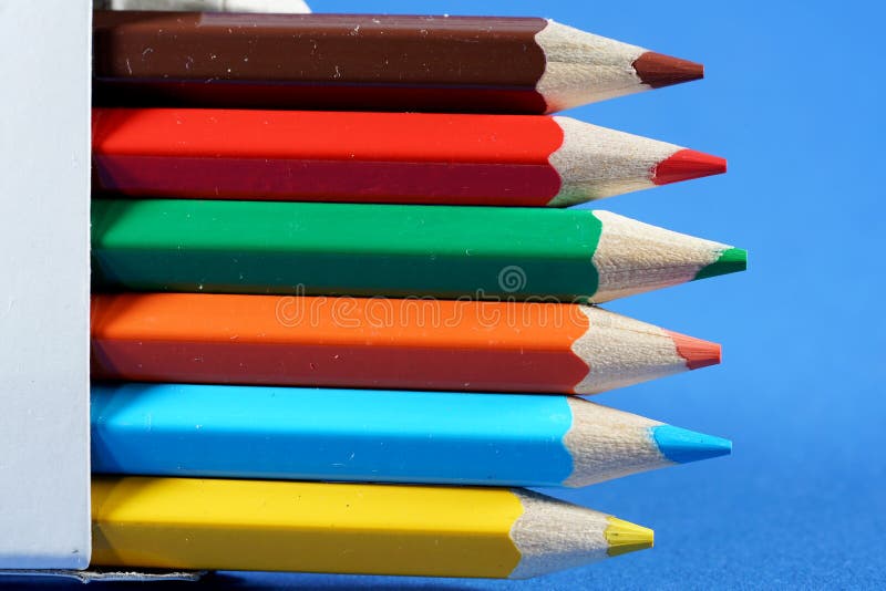 Colorful crayons, pencils with plain paper as a background with structure stock photo