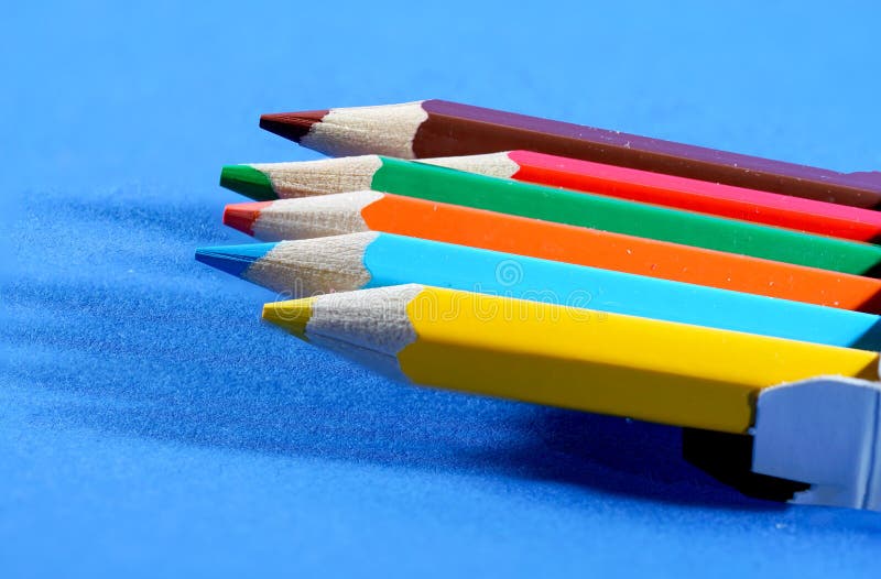 Colorful crayons, pencils with plain paper as a background with structure stock photo