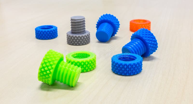 Colorful Creative Plastic Nuts Bolts and Rings made by 3D Printer on Wooden Table royalty free stock images Colorful Creative Plastic Nuts Bolts and Rings made by 3D Printer on Wooden Table royalty free stock images