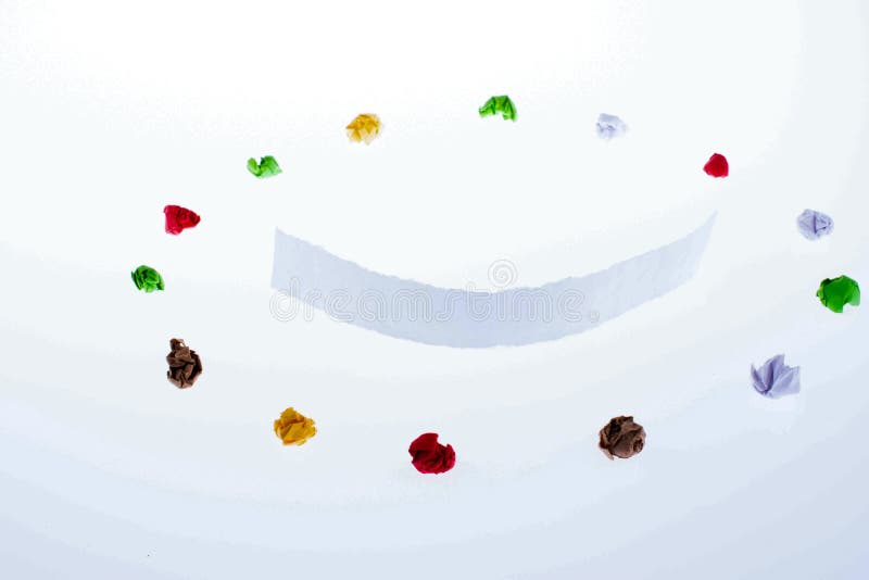 Colorful crumpled papers and a smile royalty free stock image